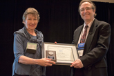 Jan Tobochnik receives the Oersted Medal from Mary Elizabeth Mogge.